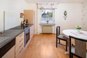 a kitchen with a counter and a table in it at Traumschmiede in Bad Emstal