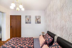 a living room with a couch and paintings on the wall at Traumschmiede in Bad Emstal