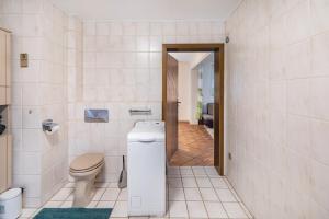 a bathroom with a toilet and a sink at Traumschmiede in Bad Emstal +14 photos