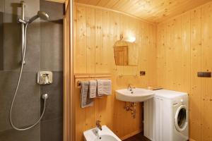 a bathroom with a sink and a washing machine at Jelerhof in Gsies +112 photos