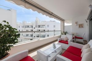 a living room with a large window with a view of a building at Acogedor apartamento 2 dormitorios in Marbella