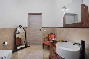 a bathroom with a sink and a toilet and a mirror at Il Cortiletto 21 in Marsala +41 photos