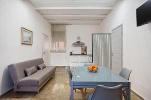 a living room with a table and a couch at Il Cortiletto 21 in Marsala
