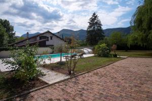 a house and a swimming pool in a yard at Villa De Marchi in Saint-Just-de-Claix