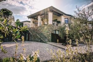 a house with a stone staircase in front of it at Maravida Vacation Rooms in Dobrovo