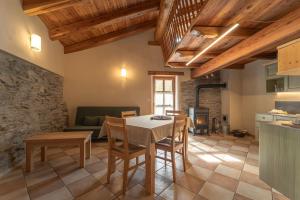 a kitchen and living room with a table and chairs at Civico 1 in Marmora