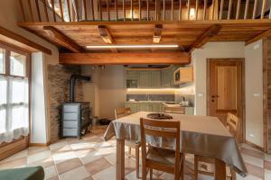 a kitchen and dining room with a table and chairs at Civico 1 in Marmora