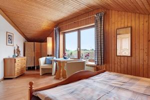 a bedroom with a bed and a table and a window at Haus Höhensonne in Höchenschwand