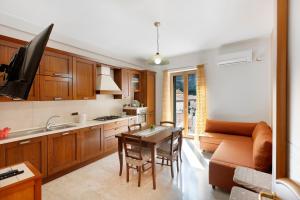 a kitchen and living room with a couch and a table at Ce Tour - Nonni's Lemon House in Cetara +12 photos