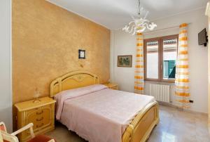 a bedroom with a large bed and a chandelier at Ce Tour - Nonni's Lemon House in Cetara