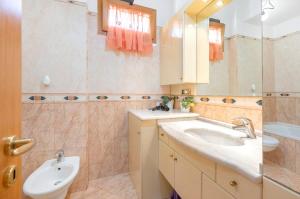 a bathroom with a sink and a toilet and a mirror at Ce Tour - Nonni's Lemon House in Cetara