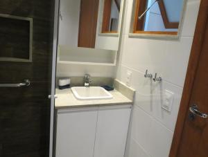 een badkamer met een wastafel en een spiegel bij Loft Felipe De Oliveira in Rio de Janeiro