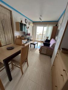a living room with a table and a dining room at Nasay Magic World in El Borseral