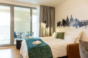 a hotel room with a bed and a balcony at AlegraStay Apartments - Dresden City in Dresden