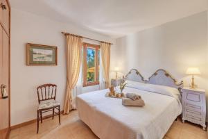 a bedroom with a bed and a chair and a window at Miravall in Puigpunyent +22 photos