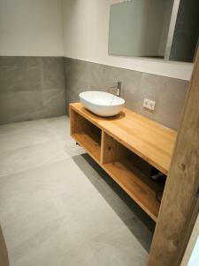 a bathroom with a white sink and a mirror at Die entspannende Eiche in San Pancrazio dʼUltimo +9 photos