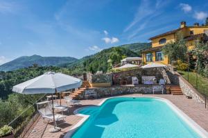 a villa with a swimming pool and a house at Podere Bucigattolo in Serravalle Pistoiese