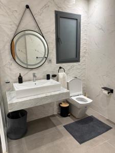 a bathroom with a sink and a toilet and a mirror at Marchica lagoon in Nador +13 photos