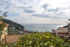 a view of the ocean from a town at Profumo di Salsedine in Bonassola