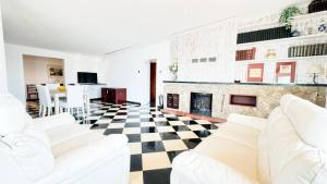a living room with white furniture and a fireplace at Best Leisure in Playa de Palma in Can Pastilla