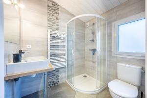 a bathroom with a toilet and a sink and a shower at Agréable Maison Sablaise in Les Sables-d'Olonne +23 photos