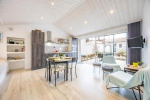 a kitchen and dining room with a table and chairs at Agréable Maison Sablaise in Les Sables-d'Olonne