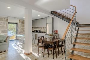 a kitchen and dining room with a table and a staircase at Casa Vilarinha Gerês in Bouro