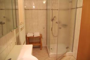 a bathroom with a shower and a sink at Gästehaus Heimenberg in Bad Rippoldsau-Schapbach +37 photos