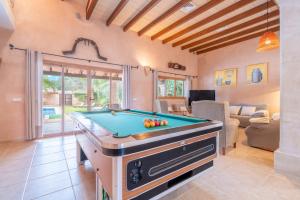 a living room with a pool table in it at Casa Brava in Santanyi