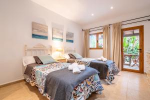 a bedroom with two beds with towels on them at Casa Brava in Santanyi +31 photos