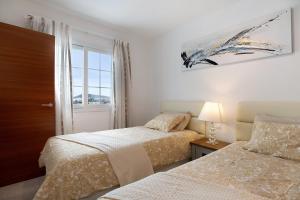 a bedroom with two beds and a window at Villa Khaleesi in Playa Blanca +22 photos