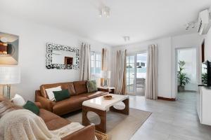 a living room with a couch and a table at Villa Khaleesi in Playa Blanca