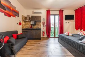 a living room with a bed and a couch at Attilio's House in Capoterra