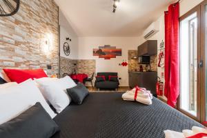 a bedroom with a large bed with red curtains at Attilio's House in Capoterra