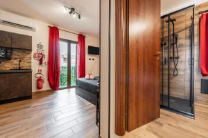 a bathroom with red curtains and a walk in shower at Attilio's House in Capoterra +21 photos