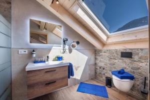 a bathroom with a sink and a skylight at Ferienwohnung Susi im Neubau in Farchant +28 photos