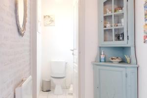 a bathroom with a toilet and a blue cabinet at Le Logis Chez Bompain in Brizambourg +24 photos