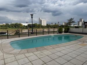 a small swimming pool with a city in the background at Puerto Amarras Apartment in Santa Fe