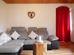 a living room with a couch and a red curtain at Haus Jurisch in Urberg