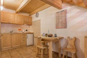 a kitchen with a small table and chairs in it at Appartamento Adamello 14 in Pinzolo