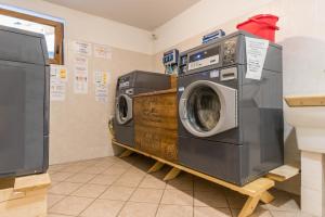 a laundry room with two washing machines on a shelf at Appartamento Adamello 14 in Pinzolo