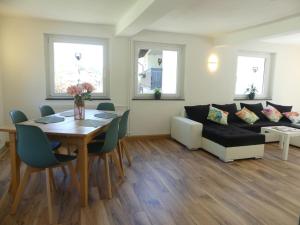a living room with a table and a couch at Ferienhaus Villa Wolffsschlucht in Oberzent