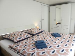 a bedroom with a bed with two blue towels on it at Ferienhaus Villa Wolffsschlucht in Oberzent