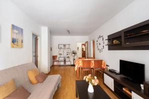 a living room with a couch and a table at Oasis in Sitges