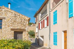 a street in an old town with stone buildings at L'amourié, Rdc, Gîte 4 Personnes in Sainte-Croix-de-Verdon