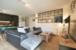 a living room with a couch and a pool table at Annecy Garden Spa Billiards in Annecy