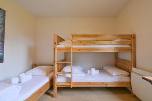 two bunk beds in a small room with white pillows at Annecy Garden Spa Billiards in Annecy