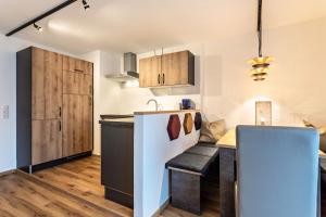 a kitchen with a table and a counter top at Bergwelt A2 in Niederau +17 photos