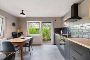 a kitchen with a wooden table and a dining room at Wanderer Lodge am Breitenstein in Bissingen an der Teck