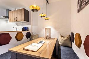 a dining room with a wooden table and chairs at Bergwelt A2 in Niederau